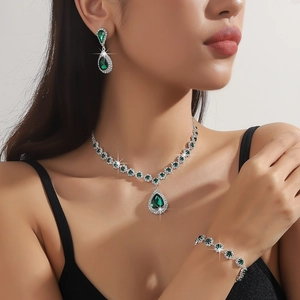 Elegant green pear-cut crystal necklace, earrings and bracelet set on a model