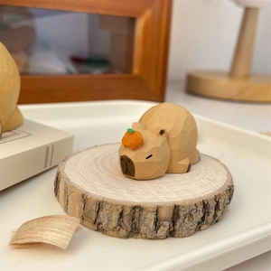 Handcrafted wooden Capybara figurine with orange on head, minimalist home office decor