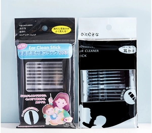 Close-up of Japanese style adhesive ear clean sticks in two packaging designs with black tips