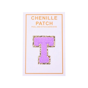 Macro detail of purple chenille letter T patch with gold glitter edge and peel adhesive