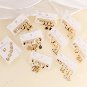 Golden stainless steel earring set featuring butterfly, star, moon, and evil eye motifs