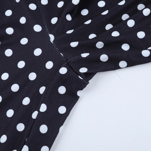 Detailed view of durable stitching and elastic polka dot fabric on women's hooded tracksuit