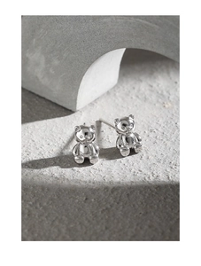 Macro shot of 925 sterling silver bear stud earrings with high-polished metallic finish