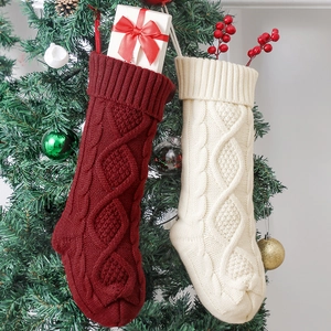 Classic 46cm cable knit Christmas stockings in red and cream hanging on a festive tree