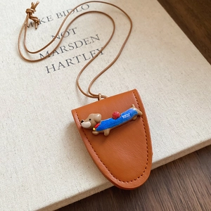 Close-up of brown leather eyeglass case featuring a cute 3D dachshund dog mascot