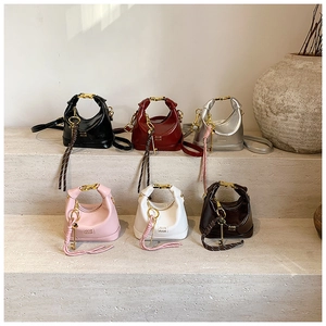 Detailed arrangement of mini crescent hobo bags in six colors with metallic handles