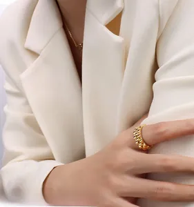 Detail of retro 18k gold plated stainless steel ring with watch band link texture