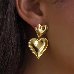18K gold double heart earrings on model showing shiny finish and minimalist style