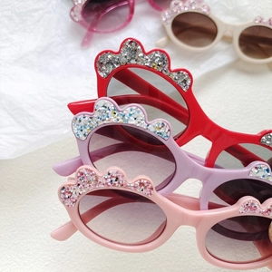 Kids colorful sequin sunglasses with oval frames and glitter crown design in various colors