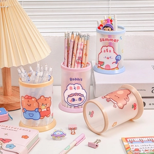 Set of four cute cartoon folding pen holders in pastel colors on a tidy desk setup