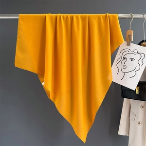 Detailed texture of yellow cotton linen shawl draped elegantly for styling