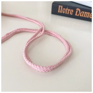 Macro shot of pink braided drawstring with detailed texture and cross-weave pattern