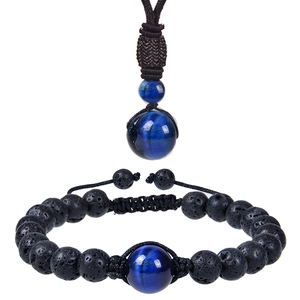 Detail view of blue tiger eye and black lava stone necklace and bracelet jewelry set