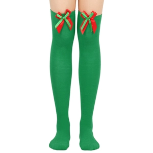 Detail of green Christmas over-the-knee socks with red ribbon bow on a model