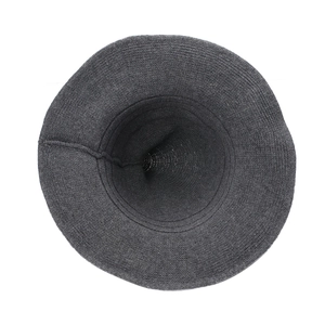 Flat lay view of a dark grey knitted witch hat with a wide brim and soft texture