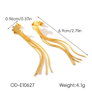 Macro shot showing dimensions of gold flower tassel earrings with snake chain details
