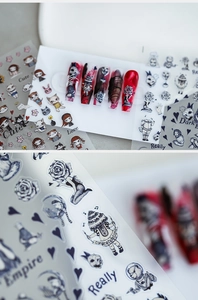 Macro detail of 5D gothic nail stickers featuring dark rose and skull motifs