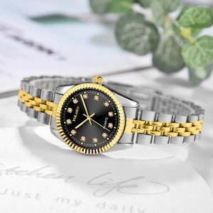 Detail of a two-tone steel watch with black sunray dial and crystal hour markers