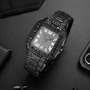 Macro shot of black iced-out square watch with Roman numerals and calendar display