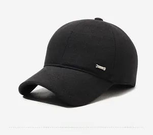 Detail of a black wool winter baseball cap showing side metal trim and thick fabric texture