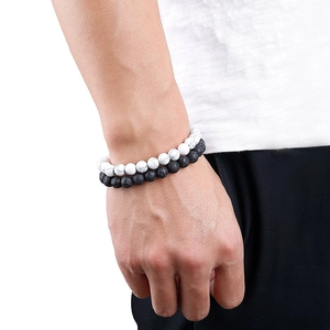 Men's natural lava stone and white marble beaded bracelet set on white background