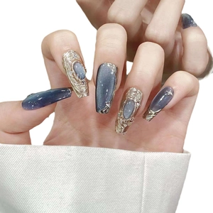 Blue cat eye press-on nails with champagne gold metallic texture and pearl accents