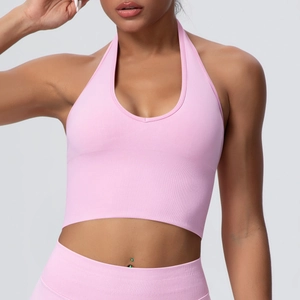 Detailed texture of pink ribbed knit halter sports bra for yoga and gym activities