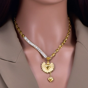 Golden heart pendant necklace with sunburst texture and rectangular crystal link accents