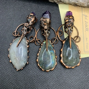 Détail de pendentifs vintage en bronze avec crâne d'oiseau, labradorite et améthyste