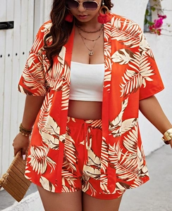 Detail of tropical leaf print on lightweight two-piece orange summer vacation outfit