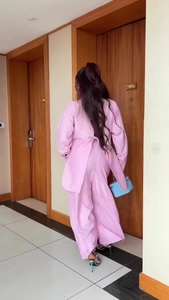 Pink two-piece set featuring back-tie long sleeve top and flowing wide-leg trousers