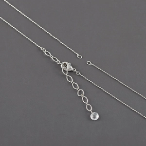 Silver-plated cross chain with lobster clasp and clear faceted bead on extension