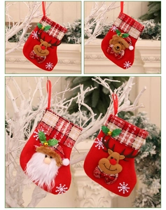 Detail of small fabric Christmas stockings with reindeer, bear, Santa, and snowman designs
