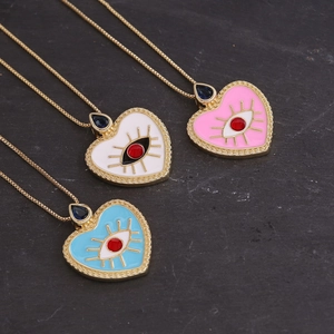 Detailed view of heart-shaped evil eye pendants in white, pink, and blue enamel