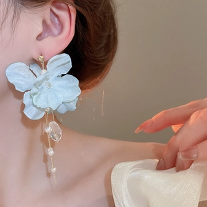Detail of light blue fabric flower earrings with pearls and crystal fringe tassels
