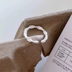 Silver braided rope open ring with a textured twist design and metallic brushed finish