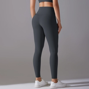 Detail view of high waisted charcoal grey yoga leggings with peach butt lifting design