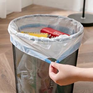 White thickened drawstring trash bags with blue handles shown in a black mesh bin