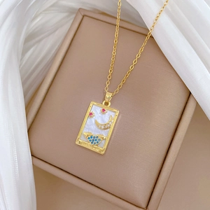 Golden tarot moon necklace with shell base and multicolor gems on silk background