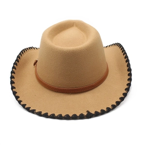 Detail of camel wool felt cowboy hat featuring black whipstitch brim and leather band