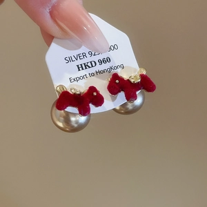 Detailed view of red flocked dog-shaped earrings with pearls and Silver 925 needle