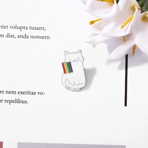 Cute white cat enamel pin holding a rainbow flag, perfect badge for backpack decoration