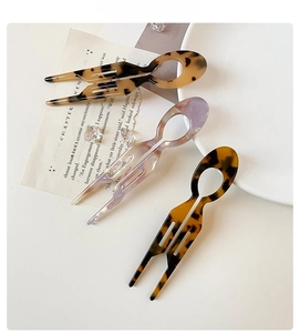 Three-piece set of acetate U-shaped hair pins with amber and marble texture finishes