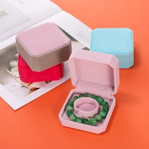 Detailed view of colorful octagonal velvet jewelry boxes for bracelets in various tones