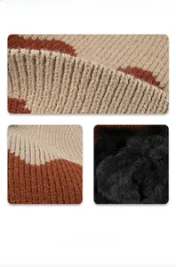 Detail of color-block knit exterior and thick black fleece lining for winter warmth