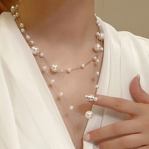 Detail of double-layer pearl necklace showing lustrous white pearls and elegant drape