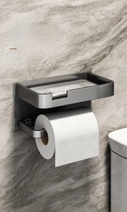 Detail view of gun-grey wall-mounted tissue holder with storage shelf in luxury bathroom