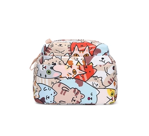 Detail of colorful cartoon cat patterns on water-resistant nylon school backpack