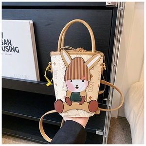 Detail of small bucket bag with cartoon rabbit motif and monogram pattern