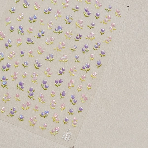 Macro shot of TO3834 tulip nail stickers with shimmering shell light and floral patterns
